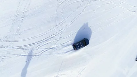Car drifting on snow top Stock Footage 236423135