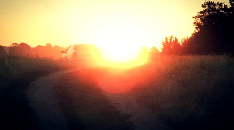The car drive away into the rays of rising sun Stock Footage 34380802