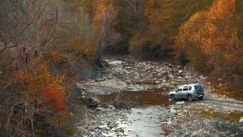 Car drive over a dry river. Outdoor aerial view. Russian landscape. Slow motion. Stock Footage 165773894