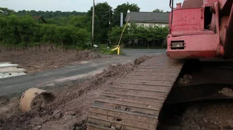 Car drive past back-hoe in parking lot 스톡 동영상 10586230