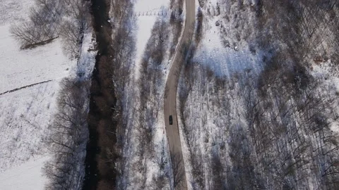 Car drive in snow winter day on the road in mountain range aerial view Video stock 232802085