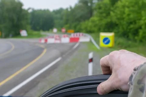 Car driver hand on the background of a blocked road Stock Photos