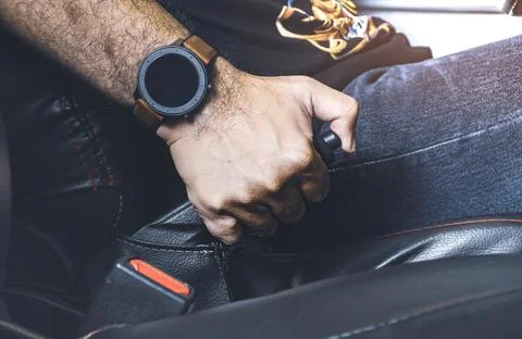 Car driver pulling handbrake lever in the car on the parking Stock Photos