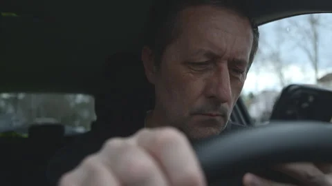 Car driver reacting to upsetting text message on phone, reading bad news on.. Stock Footage 339273837