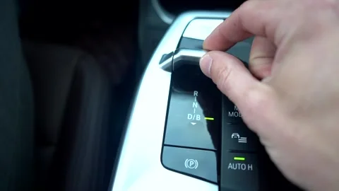Car driver shifting gear selector lever on car. Hand close-up. Pressing buttons  Video stock 316255163
