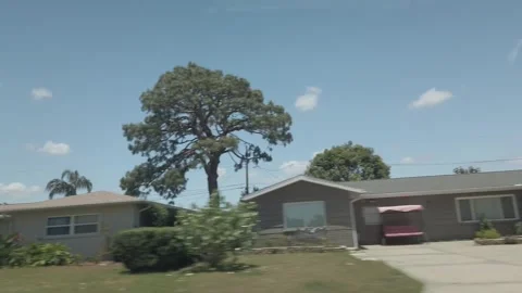 Car Driver side  Window View Of Road In Florida City driving down street. Stock Footage 240600317