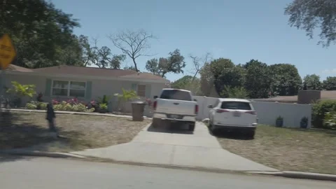 Car Driver Side Window View Of Road In Florida City Driving Down Street. Stock Footage 240600349