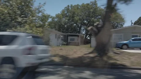 Car Driver Side Window View Of Road In Florida City Driving Down Street. Stock Footage 240600528