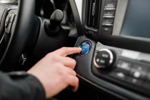 Car driver starting the engine Start, stop engine button. Stock Photos