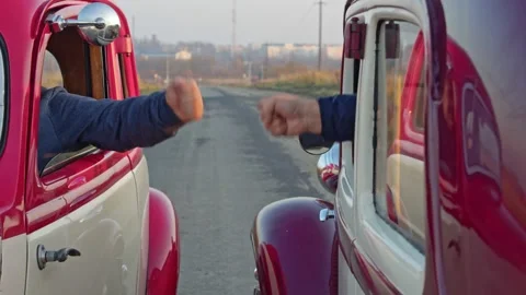 Car drivers draw lots to decide who drives first, a competition between old Stock Footage 165685438