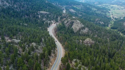 A car drives along a winding road in the Colorado mountains Stock Footage 247363879
