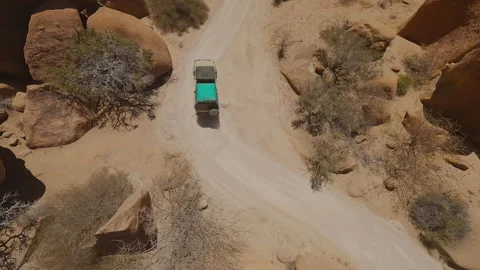 A Car Drives Between Large Stones view from the fpv drone Stock Footage 297254903