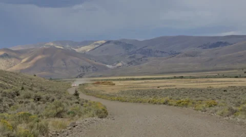 A car drives down a dirt road in Idaho Stock Footage 36298040