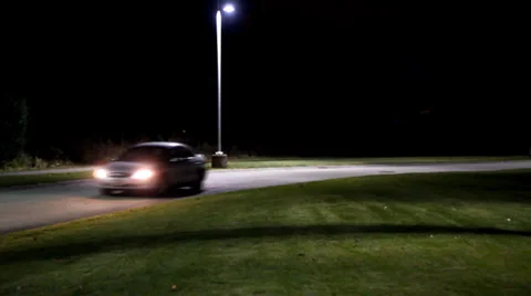 Car drives down empty road at night Stock-Footage 35753529