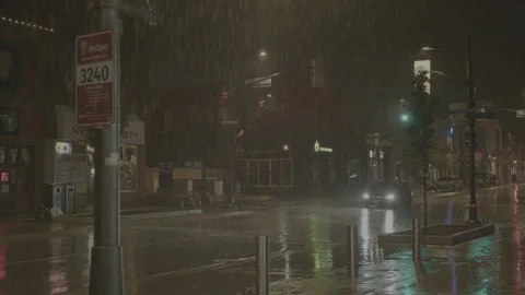 Car drives down main road of town while is rains at night - Wide shot Stock-Footage 270255037