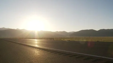 Car drives down road during dusk Stock Footage 520722