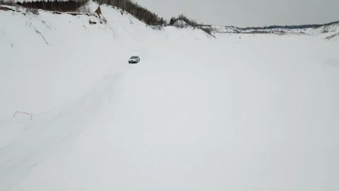 Car drives by ice track covered by snow not far 库存影片 299632095
