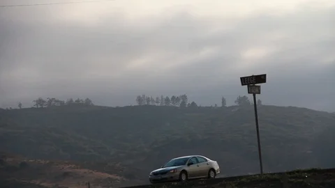 Car drives by intersection in the middle of nowhere Stock Footage 109171109