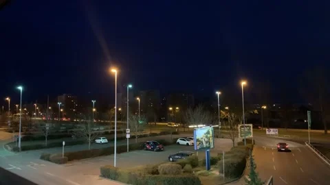 Car drives at night over an empty parking lot in the streets of the city Stock Footage 173506749