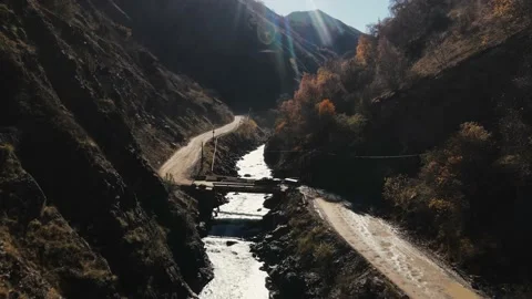 A car drives over a bridge over a river in a mountainous area Stock Footage 171297345