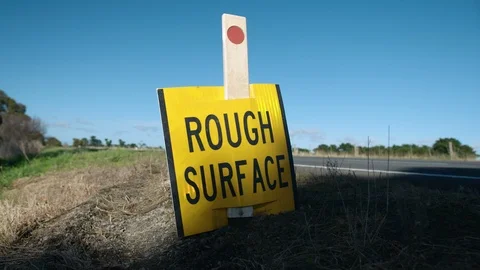 Car drives past Rough Service sign on Victorian rural highway - HD 25P. Stock Footage 87844142