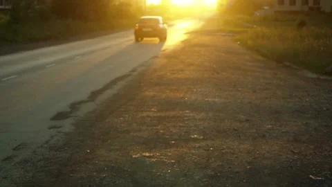 The car drives on the road in the backlight of the sunset Stock Footage 158916805