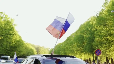 Car Drives with Russian Flag Past Victory Park in Riga on May 9 - Provocative Stock Footage 306127604