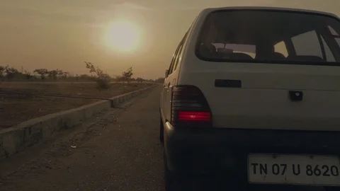 Car Drives Off Into Sunset Stock Footage