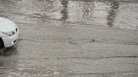 Car drives through a large puddle of dirt Stock Footage 61941885