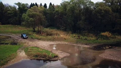 A car drives through a large puddle. Stock Footage 105200674