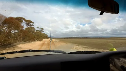 Car drives through mud pit 스톡 동영상 112160712