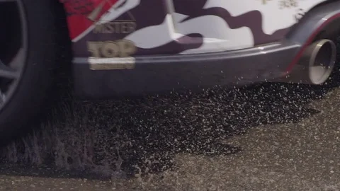 A  car drives through a puddle in slow motion Video stock 75443381