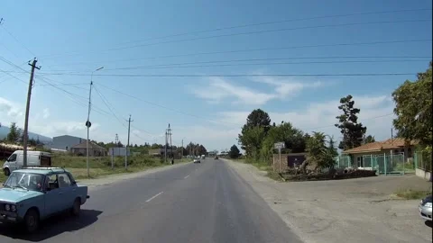 The car drives through a typical Georgian province Stock Footage 151010632