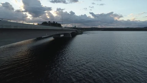 Car drives towards sunset next to a lake Stock Footage 86486520