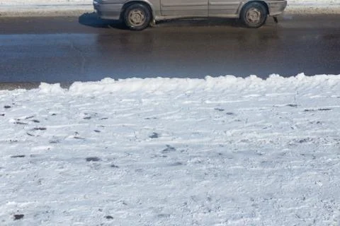 Car drives in the winter on a dirty road Stock Photos