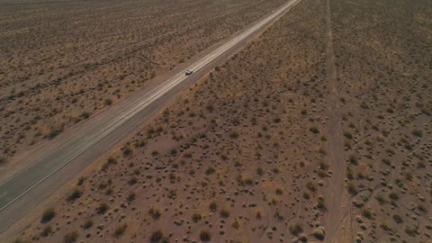 Car Driving Alone on Desert Road Near Las Vegas Stock Footage 325982560
