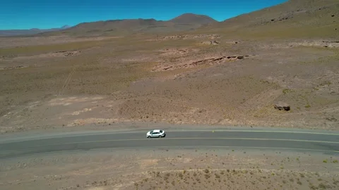 Car driving alone in the dessert road of the Atacama Stock Footage 260778037