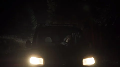 A car driving along a bumpy country road at night suddenly stopped Stock Footage 303569489