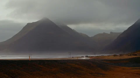 Car Driving Along on Empty Road with Mountain in sunset, North coast, Iceland Stock Footage 260918243