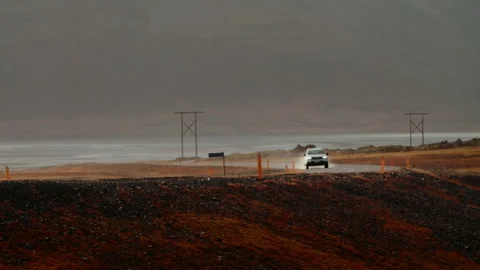 Car Driving Along on Empty Road with Mountain in sunset, North coast, Iceland Stock Footage 260920844