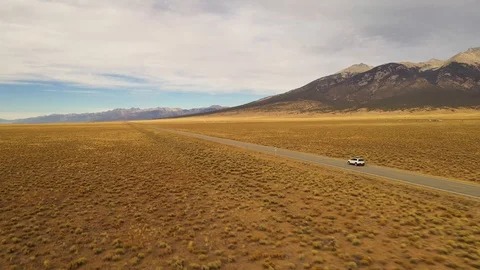 Car Driving Along Mountain Back Road Sunset Aerial Shot 4K Stock Footage 119831755