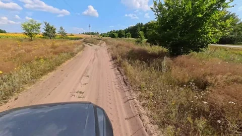The car is driving along a path in the fresh air in nature in summer. Stock Footage 319031687