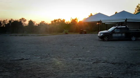 Car driving by on beach at sunset Stock-Footage 23355825