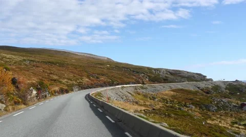 Car driving between mountains and sea full of autumn colors, from Olderfjord  Stock Footage 68615087