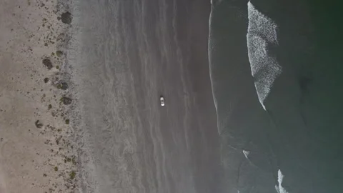 Car driving on black beach view from drone from above Stock Footage 264603302