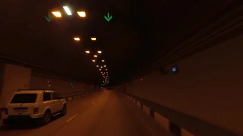 Car driving on city road through dark illuminated tunnel Stockbeeldmateriaal 147236907