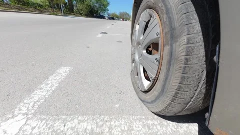 Car driving on a completely flat tire on the asphalt road Stock Footage 334315579