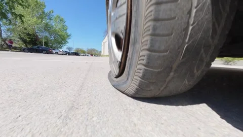 Car driving on a completely flat tire on the asphalt road Stock Footage 334315674