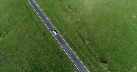 Car driving on countryside with green fields on both side Stock Footage 86180296