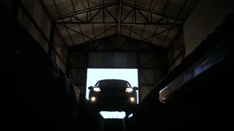 Car driving in dark garage for testing and maintenance service with lights Stock Footage 143174002